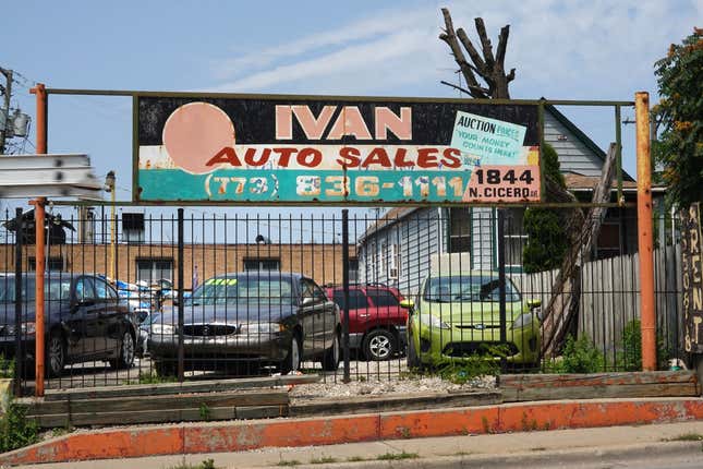 Used cars are offered for sale at a dealership on July 11, 2023 in Chicago, Illinois.