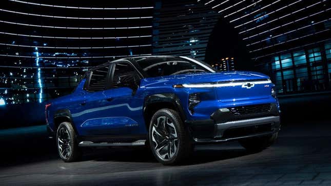 A blue 2024 Chevrolet Silverado EV parked outside near buildings