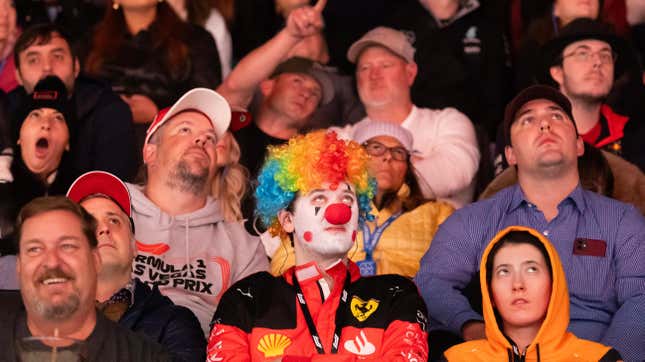 A Ferrari fan watches the qualifying session in makeup at the Las Vegas Grand Prix early Saturday morning, Nov. 18, 2023 in Las Vegas, NV. 