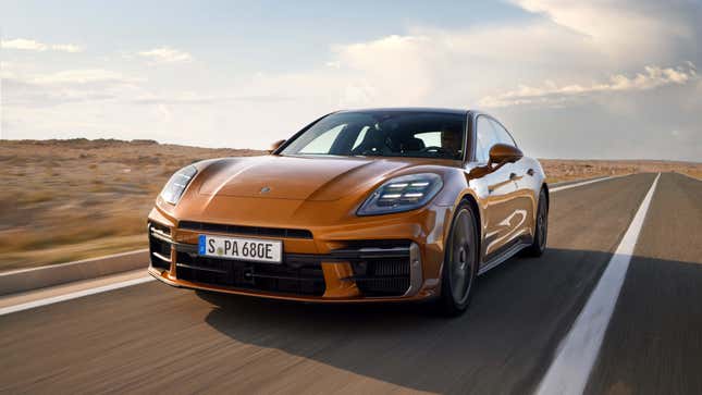 Front 3/4 view of an orange 2024 Porsche Panamera driving